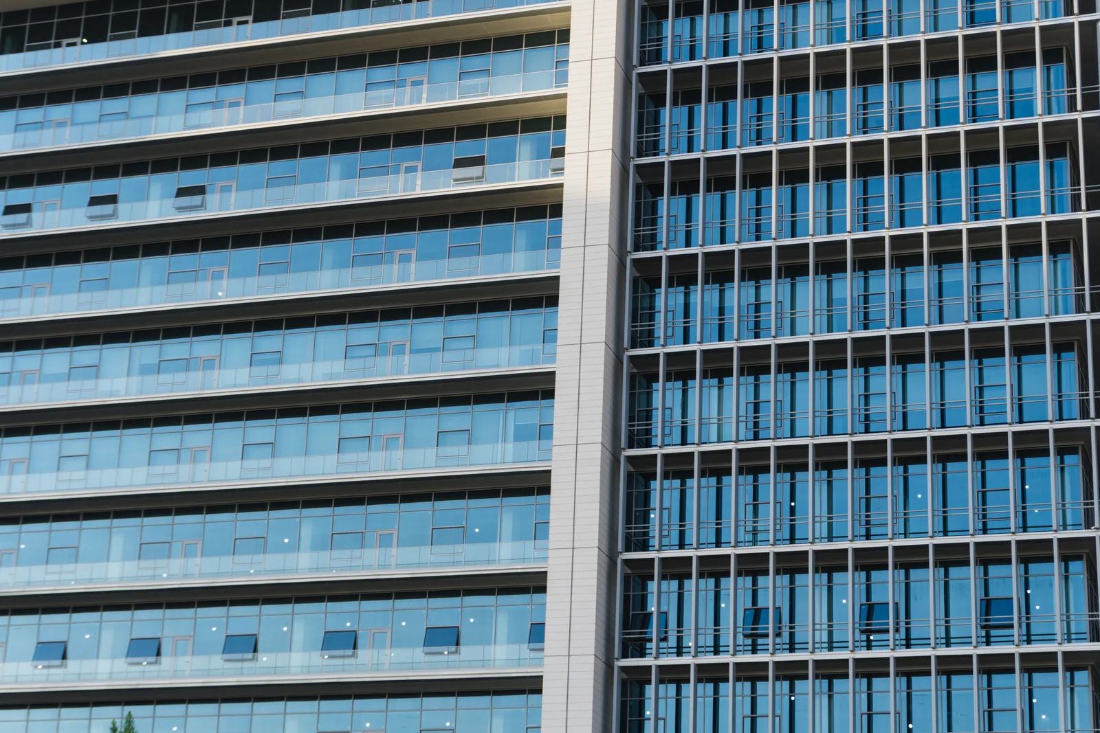 Blue glass windows and steel frames across a modern office facade.